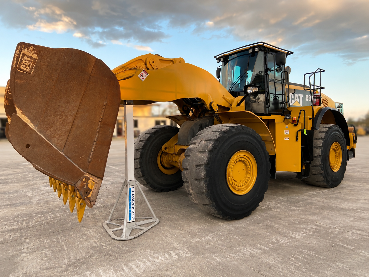 CAT 980 wheel loader bucket supported by a 12t Composite Bucket Stand during maintenance setup