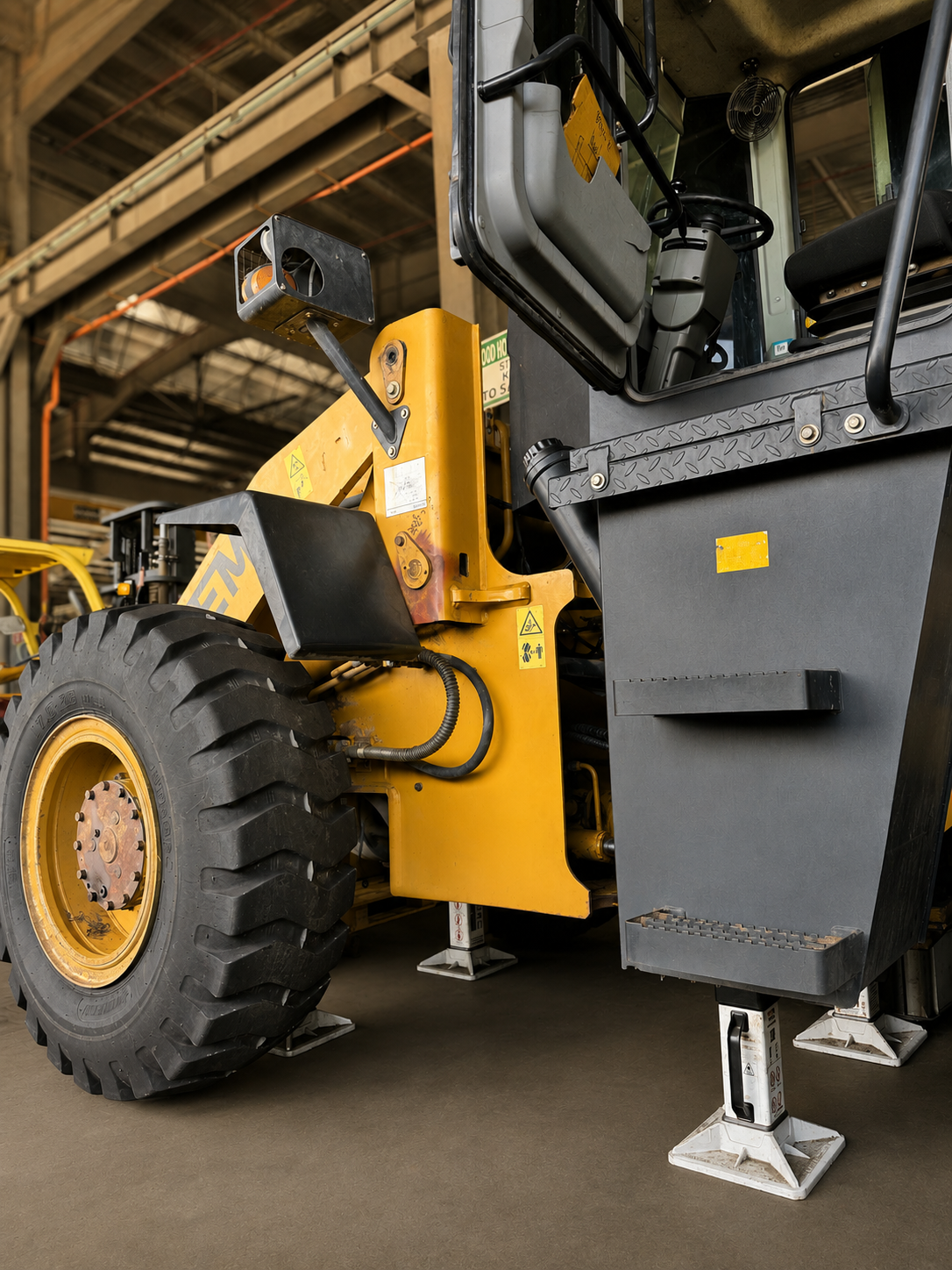 25t Composite Support Stands supporting a wheel loader in an industrial workshop