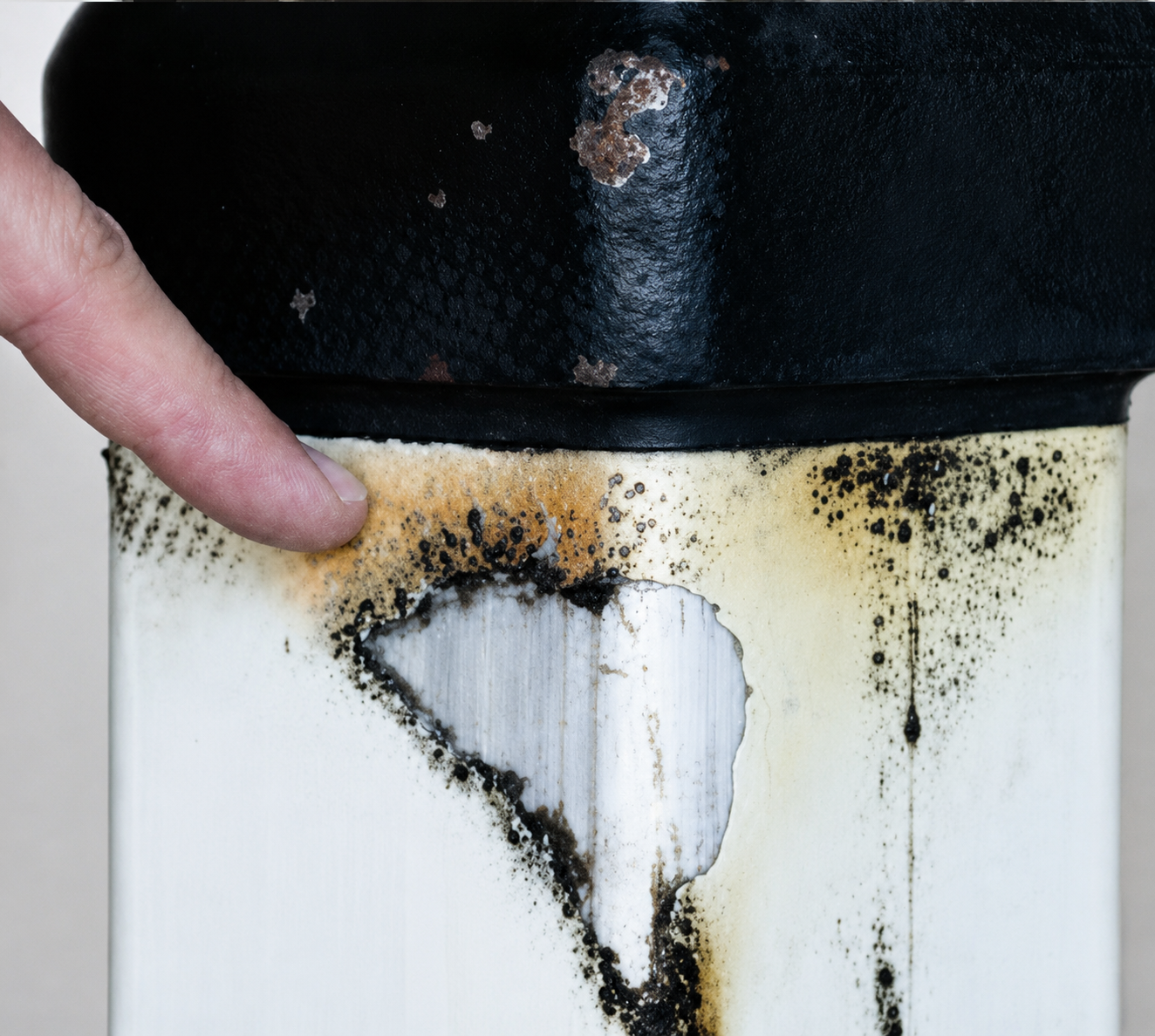 Heat damage to a Composite Support Stand column with burned label area and exposed composite material