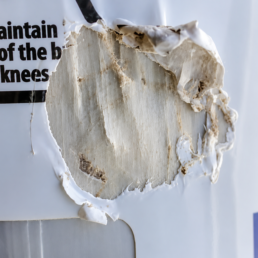 Impact damage to a Composite Support Stand column showing damaged label and exposed composite material